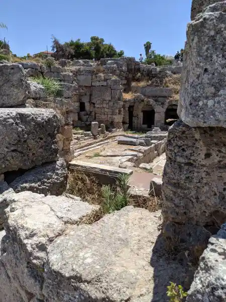 Interior view of Peirene Fountain showing the carved stone basin with steps and arched reservoir chambers at Ancient Corinth